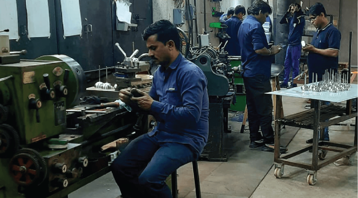 Metal lathe machine operator at fabrication workshop, Surat